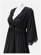 A black nightgown with floral lace trim on the V-neckline, waist, and three-quarter sleeves, displayed on a white mannequin torso against a light gray background.