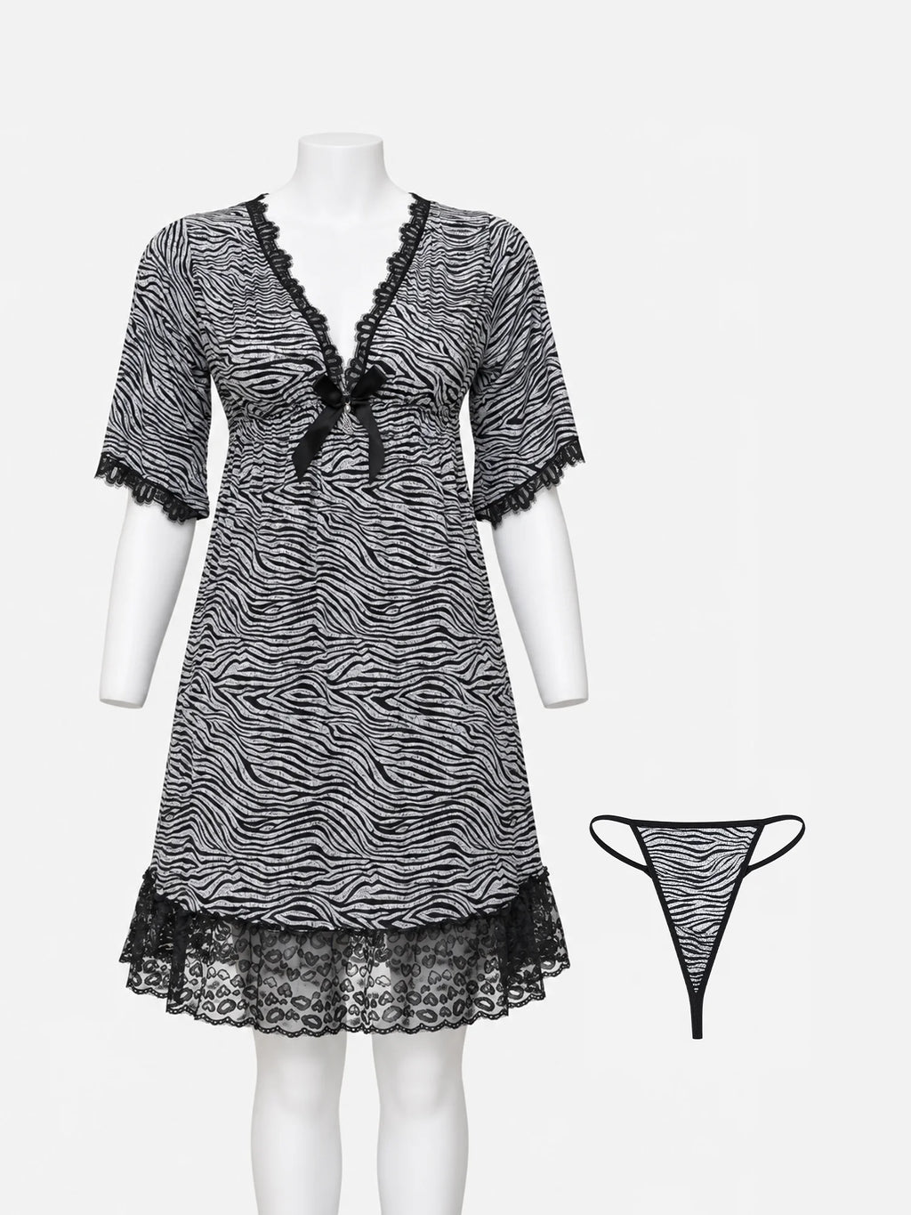 A black and white zebra-print babydoll nightgown with black lace trim and a small bow at the neckline, displayed on a white mannequin. A matching thong is shown to the right against a light gray background.