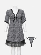 A black and white zebra-print babydoll nightgown with black lace trim and a small bow at the neckline, displayed on a white mannequin. A matching thong is shown to the right against a light gray background.