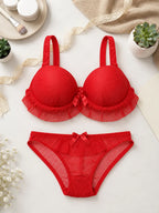 Red bra and matching panty set with lace-style trim and bow details
