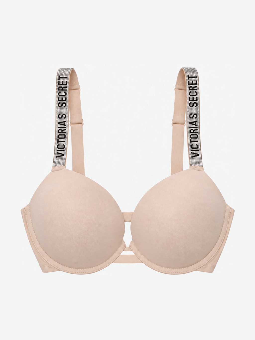 A light beige wireless bra with wide shoulder straps featuring the text 'VICTORIA'S SECRET' in black on a glittery background, shown against a plain light gray background.